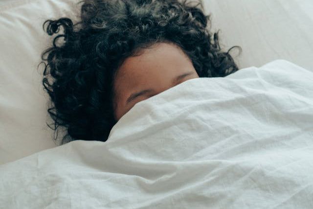 Woman sleeping under the sheets