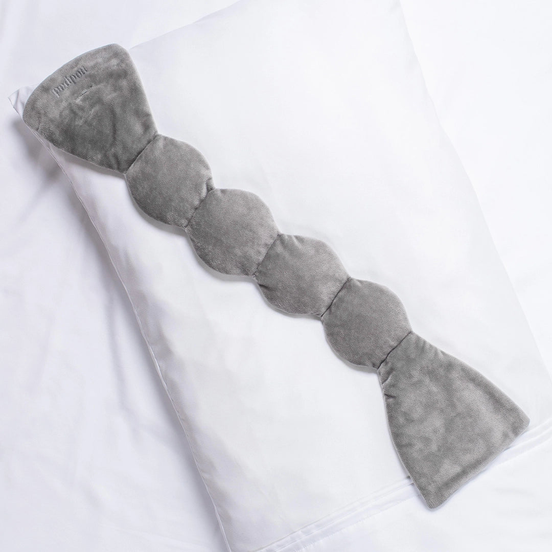 Grey Weighted Eye Mask on a pillow