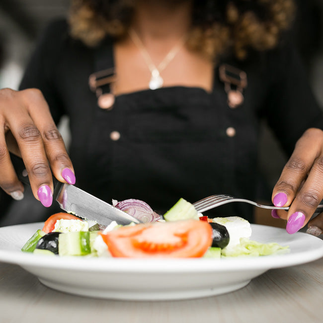 Close up of woman eating a healthy salad.
