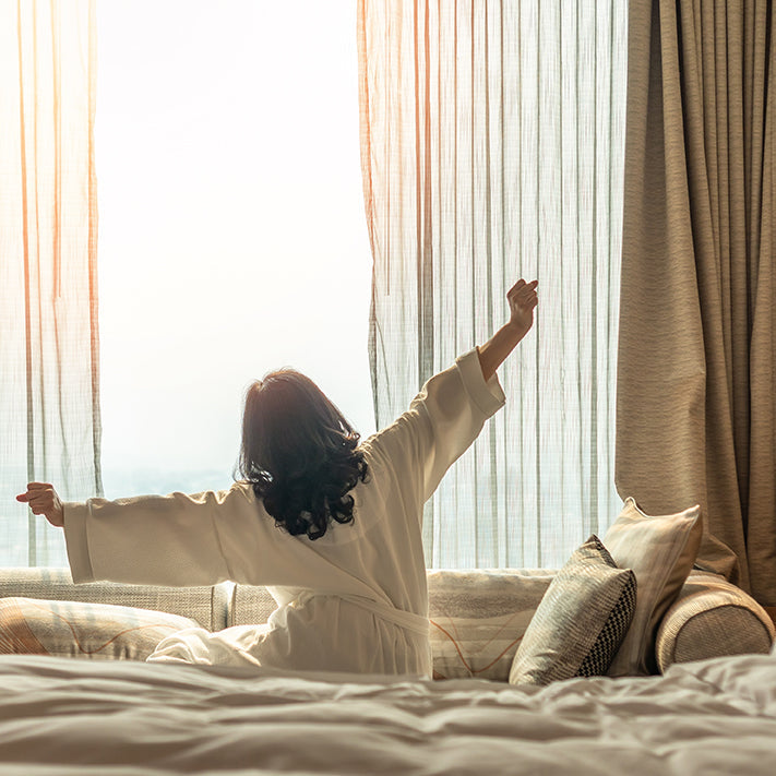 Woman Waking Up to a Sunshine Filled Window