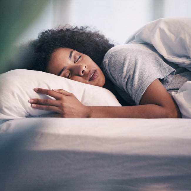 Woman Sleeping in her Bed in the early morning