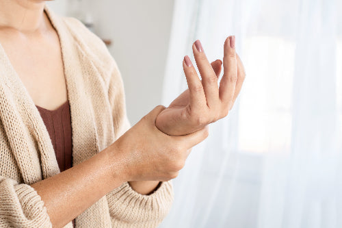 Woman holding wrist
