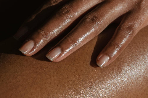Closeup of woman's hand on leg