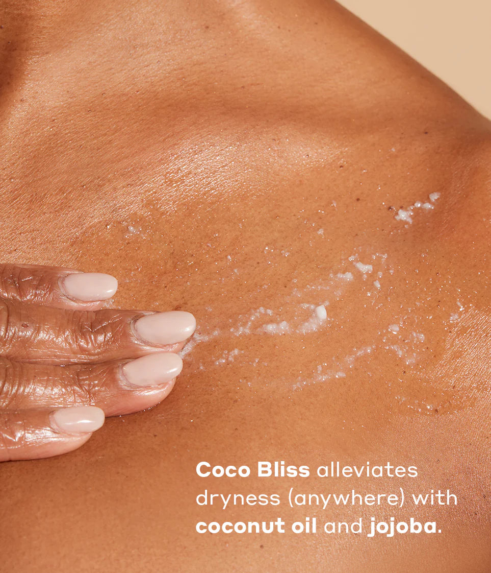 Woman applying Coco Bliss to skin- over the image reads Coco Bliss alleviates dryness anywhere with coconut oil and jojoba.