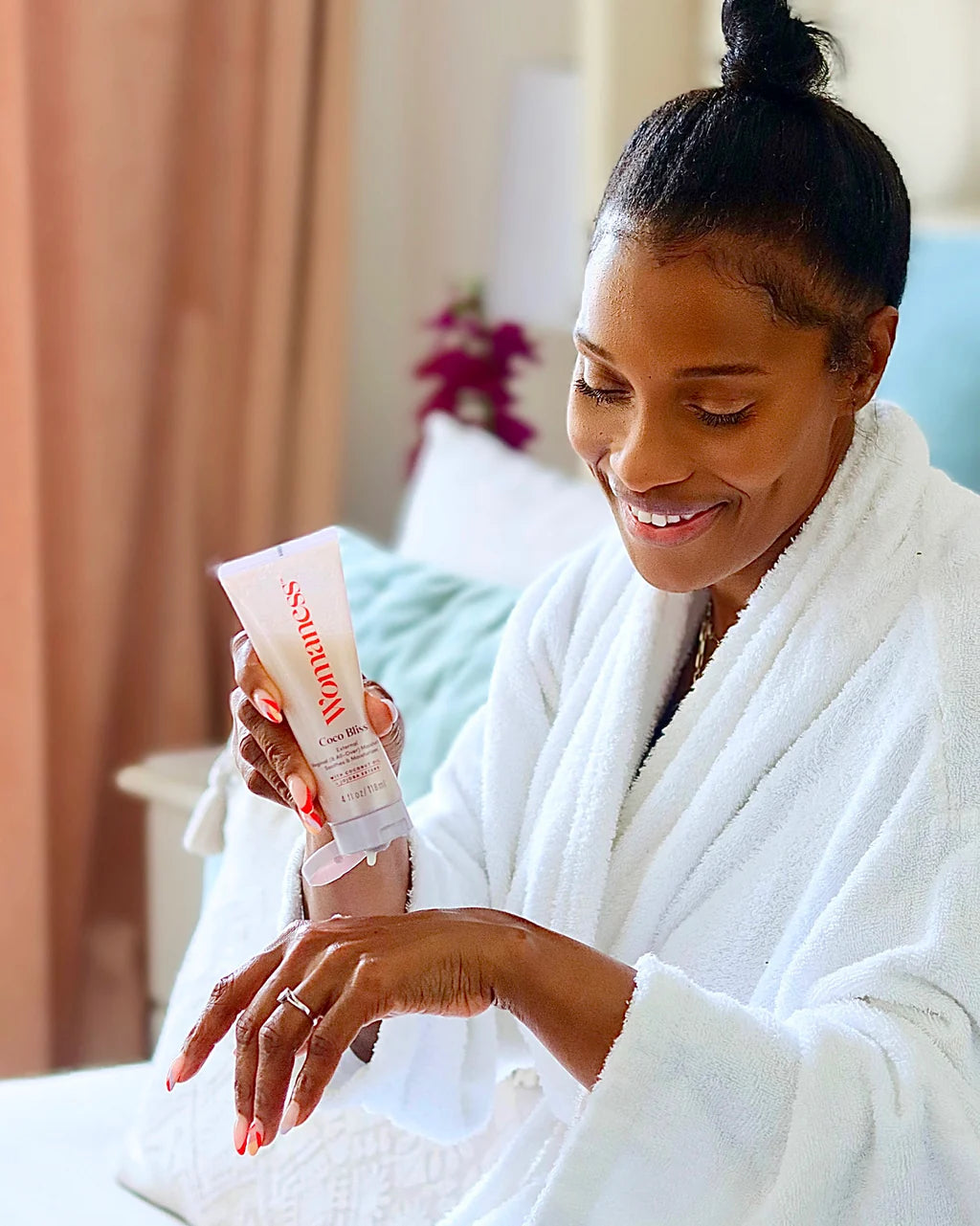 Woman applying Coco Bliss Moisturizer to her skin