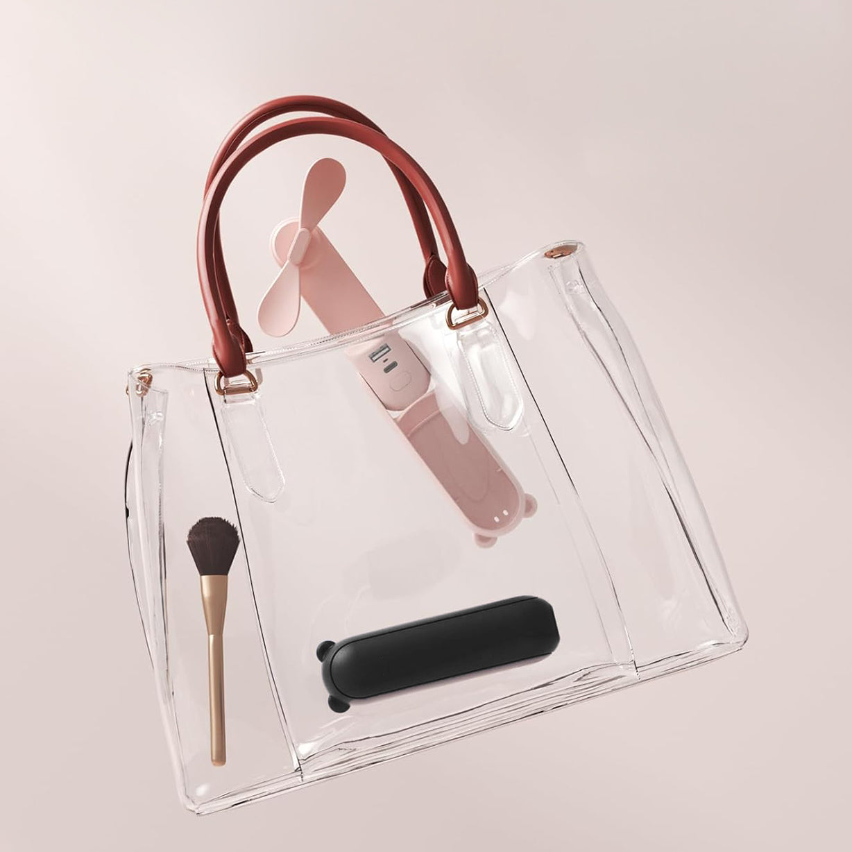 The personal mini fan placed inside a purse, showcasing its compact and portable design for on-the-go use.